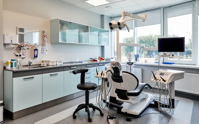 Modern dental clinic treatment room with advanced equipment and patient chai